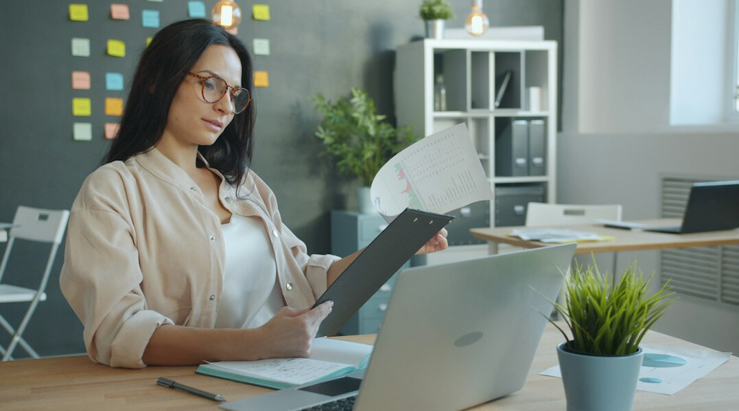 person reviewing documents at desk